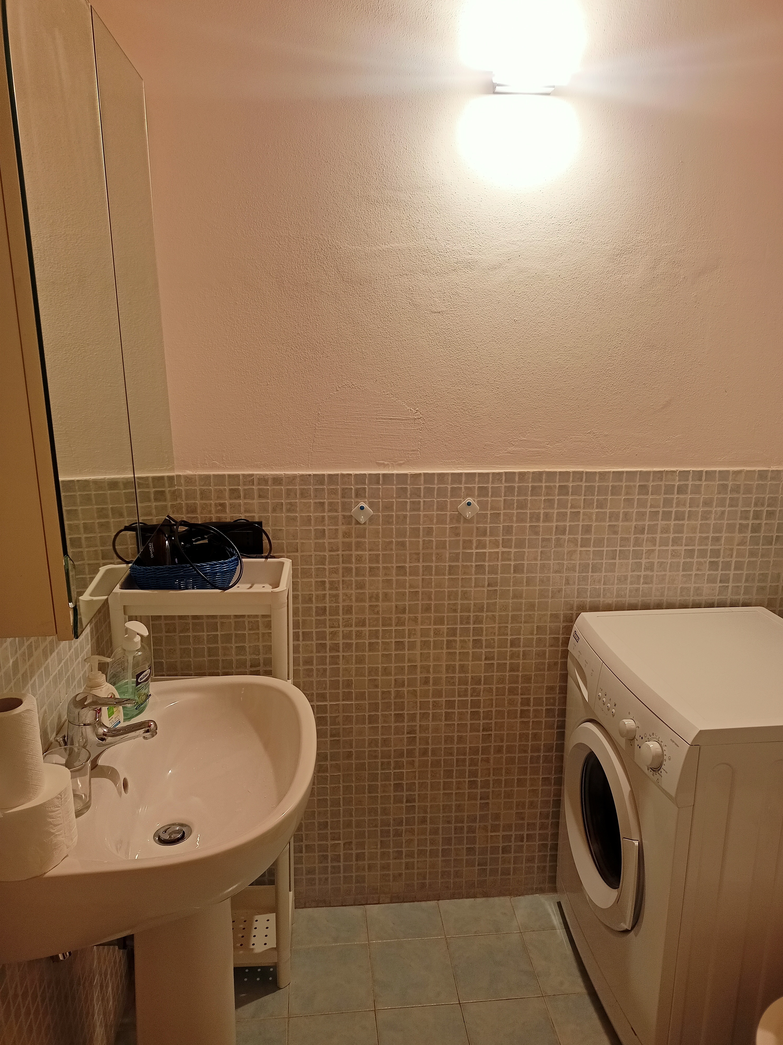 Lavandino del bagno con specchio e ripiani